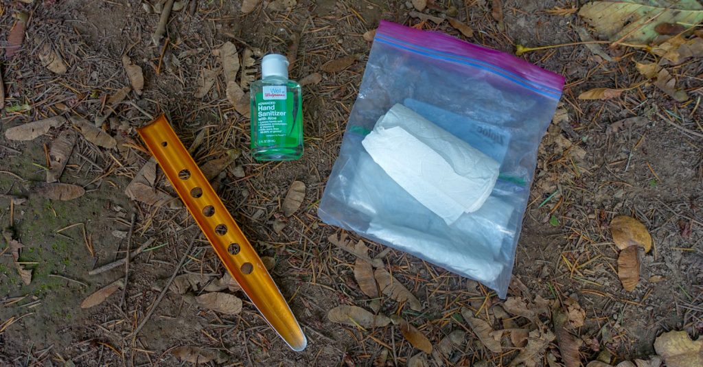 the tools for pooping in the woods (trowel, hand sanitizer and a baggie of toilet paper
