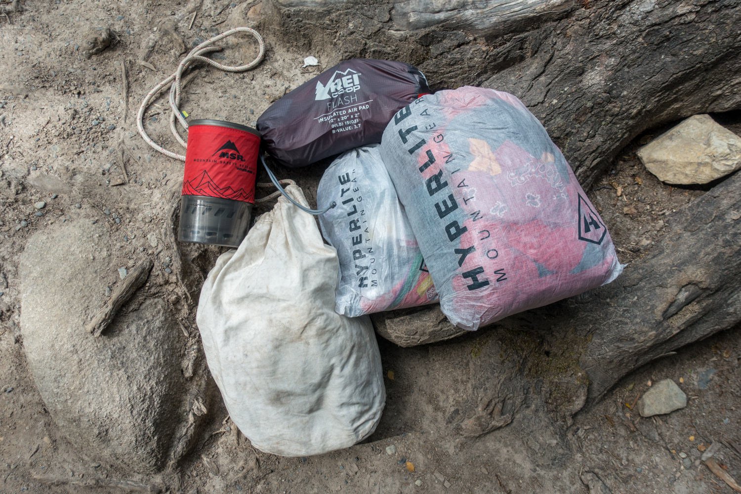a backpacker's stuff sacks on the ground