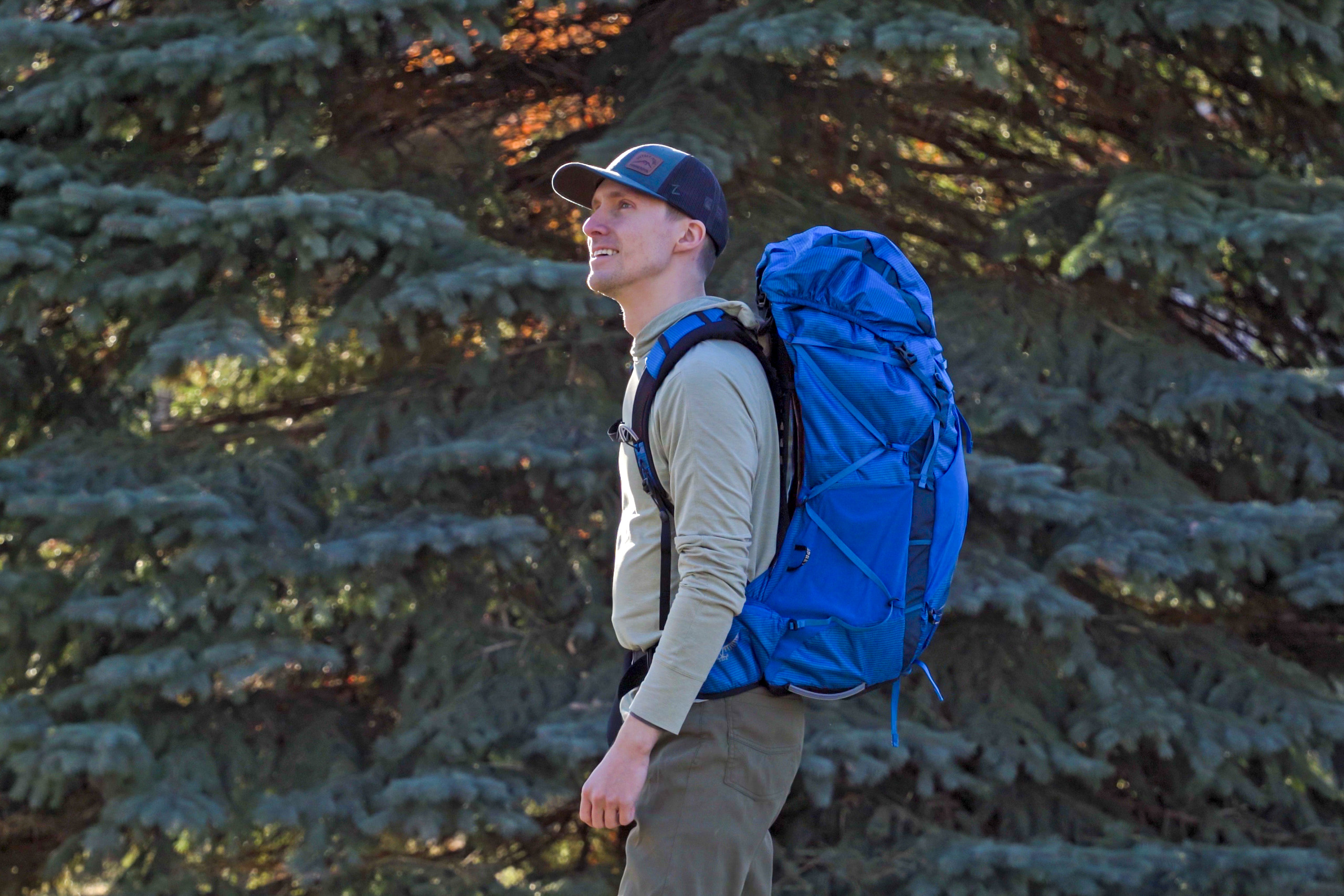 a man wears a blue backpack